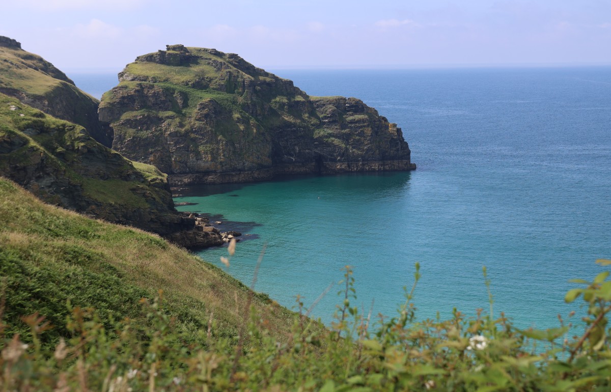 Boscastle Bay on a sunny day with cliffs and calm, turqoise waters